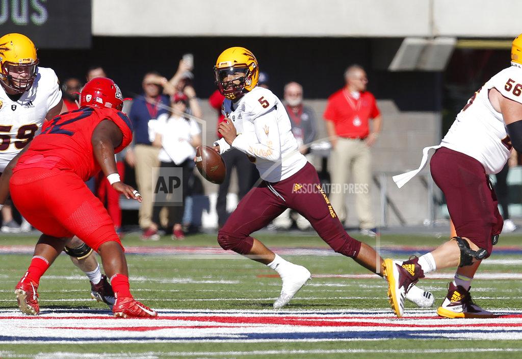 Rick Scuteri Arizona State quarterback Manny Wilkins (5) avoids a rush from the Arizona defense in the first half during an NCAA college football game, Saturday, Nov. 24, 2018, in Tucson, Ariz. (AP Photo/Rick Scuteri)