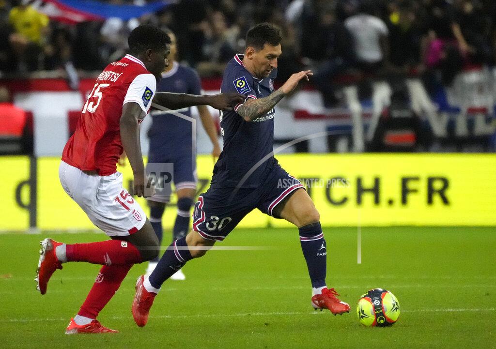 Francois Mori PSG's Lionel Messi, right, challenges for the ball with Reims' Marshall Munetsi during the France League One soccer match between Reims and Paris Saint-Germain, at the Stade Auguste-Delaune in Reims, France, Sunday, Aug. 29, 2021. (AP Photo/Francois Mori)