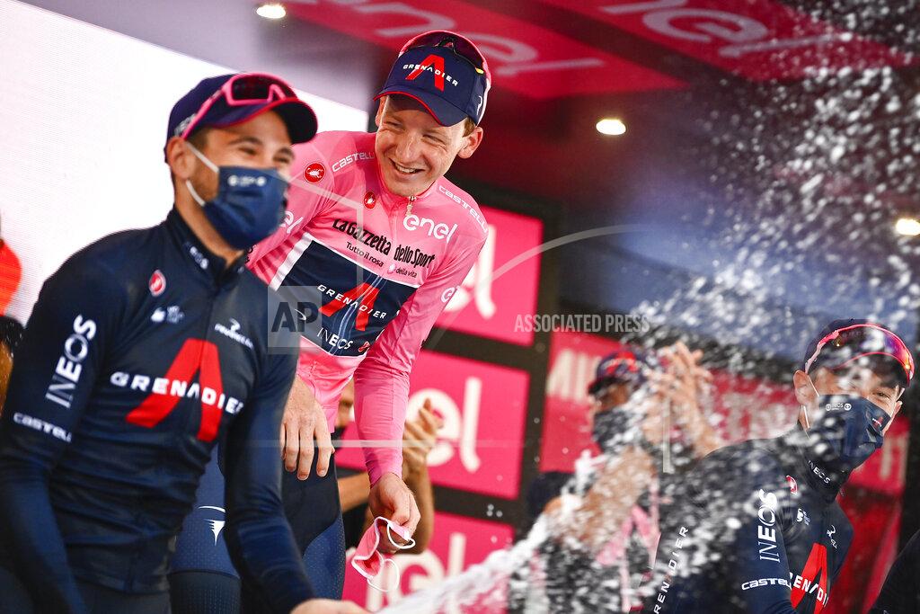 Marco Alpozzi Britain’s Tao Geoghegan Hart celebrates with teammates after winning the Giro d'Italia cycling race, in Milan, Italy, Sunday, Oct. 25, 2020. In one of the most exciting final stages of a Grand Tour, British rider Tao Geoghegan Hart won the Giro d’Italia on Sunday, edging out Australian Jai Hindley by just 39 seconds. (Marco Alpozzi/LaPresse via AP)