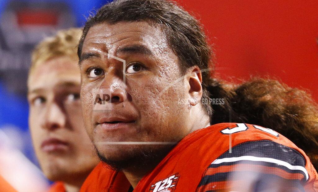 Rick Bowmer FILE - In this Oct. 12, 2018, file photo, Utah defensive tackle Leki Fotu (99) looks at the scoreboard in the second half during an NCAA college football game against Arizona, in Salt Lake City. Utah's defensive dominance in the trenches has its roots in the fierce competition among the Utes' linemen. "To me, it's just hard work," defensive tackle Fotu said. "If you put in the work and get the right group of guys to work with, and the right coaches, everything else will fall into place." (AP Photo/Rick Bowmer, File)