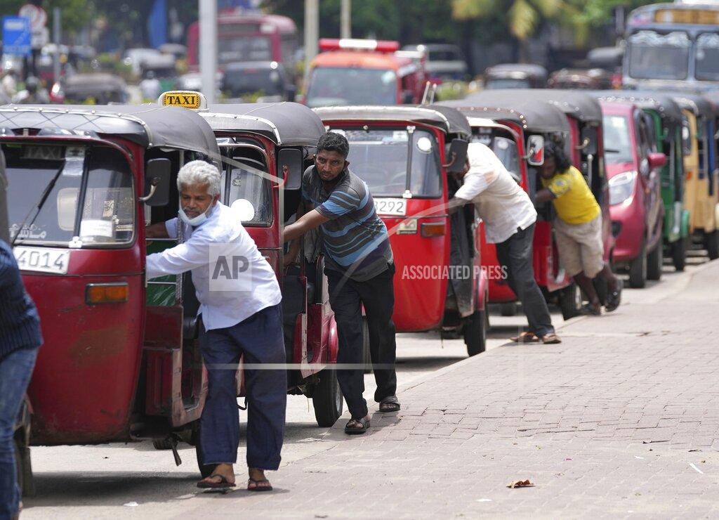 Eranga Jayawardena FILE- Sri Lankan auto rickshaw drivers queue up to buy petrol near a fuel station in Colombo, Sri Lanka, April 13, 2022. Sri Lankans are facing a severe economic crisis that has ravaged household budgets amid high inflation. Staple foods are in short supply, along with medicines.(AP Photo/Eranga Jayawardena, File)