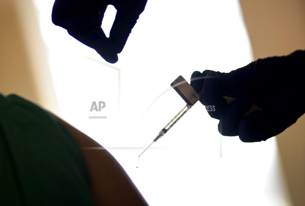 David Goldman FILE - In this Tuesday, Dec. 15, 2020 file photo, a droplet falls from a syringe after a health care worker was injected with the Pfizer-BioNTech COVID-19 vaccine in Providence, R.I. Some hospitals around the U.S. are facing complaints about favoritism and line-jumping after their board members and donors received COVID-19 vaccinations or offers for the prized inoculations. In Rhode Island, Attorney General Peter Neronha opened an inquiry after reports that two hospital systems offered their board members vaccinations. (AP Photo/David Goldman, File)