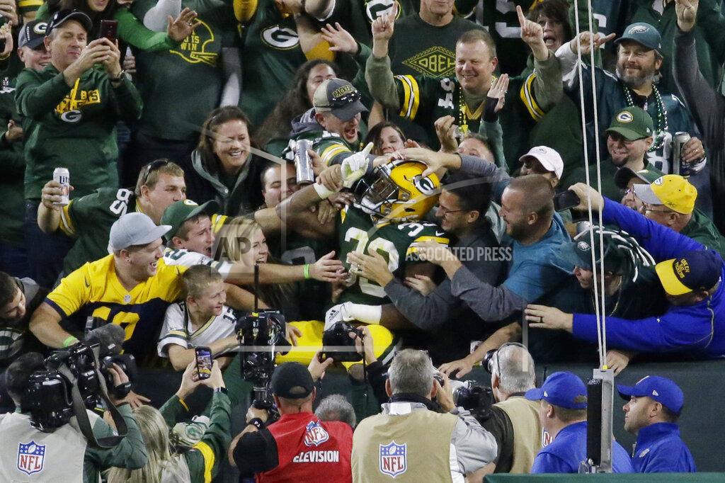 Mike Roemer Green Bay Packers running back Aaron Jones celebrates and is congratulated by fans after his rushing touchdown during the first half of the team's NFL football game against the Philadelphia Eagles on Thursday, Sept. 26, 2019, in Green Bay, Wis. (AP Photo/Mike Roemer)