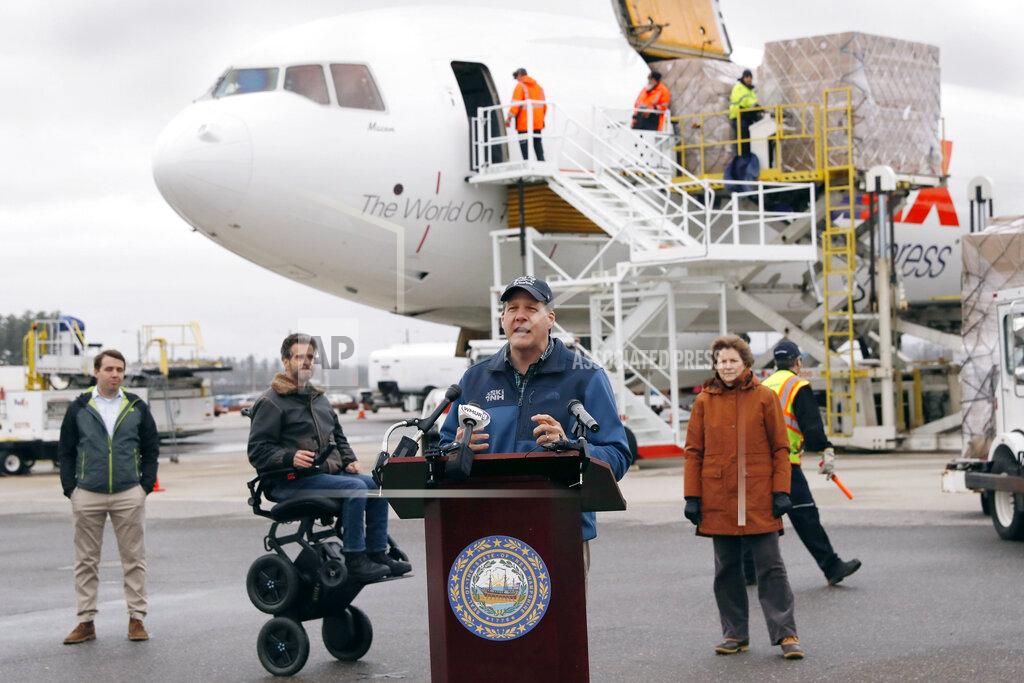Charles Krupa New Hampshire Governor Chris Sununu addresses the media as over 110,000 pounds of personal protective equipment (PPE) from Shanghai, China, delivered to protect medical workers and first responders fighting the COVID-19 virus outbreak, is unloaded from a cargo plane at Manchester-Boston Regional Airport in Manchester, N.H., Thursday, April 30, 2020. From left are U.S. Rep. Chris Pappas (D-NH), inventor Dean Kamen, Sununu and U.S. Sen. Jeanne Shaheen (D-NH). (AP Photo/Charles Krupa)