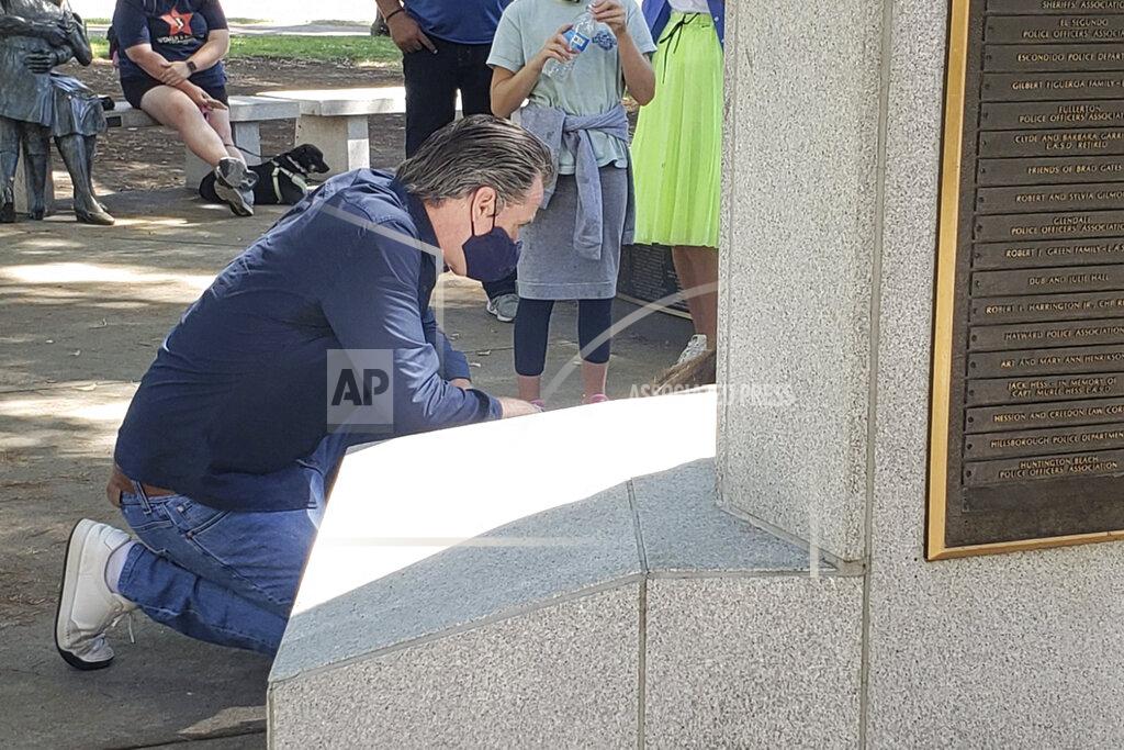 Jeff Bell In this image courtesy of KOVR CBS13 Sacramento, California Gov. Gavin Newsom cleans up graffiti left from protests Tuesday, June 2, 2020, in Sacramento, Calif. (Jeff Bell/KOVR CBS13 Sacramento via AP)