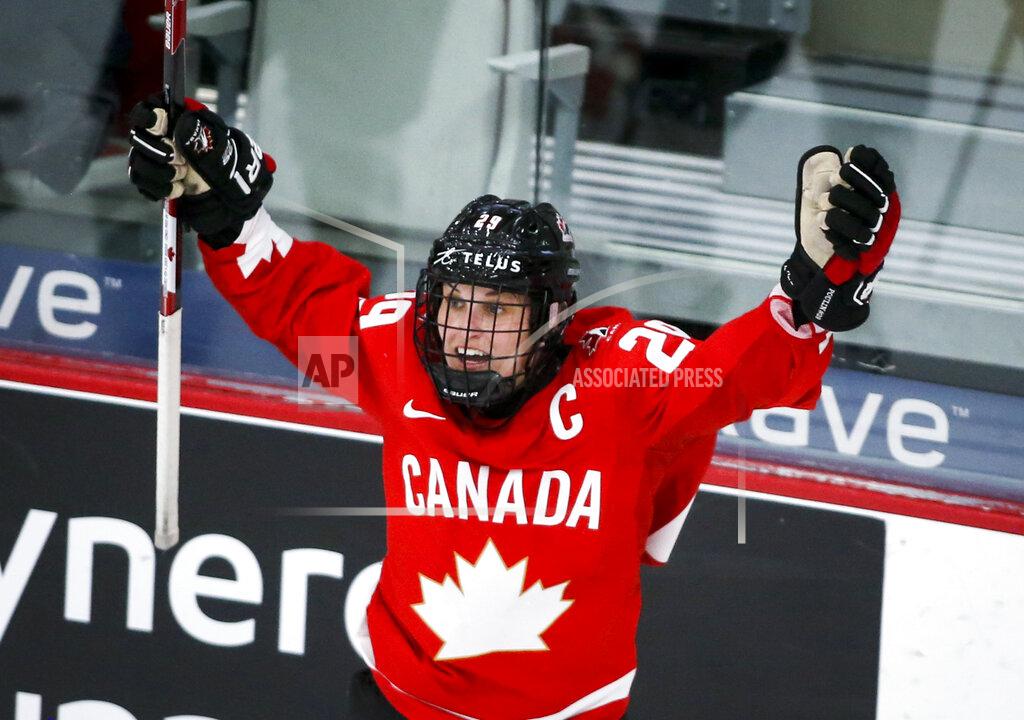 Jeff Mcintosh FILE - Canada's Marie-Philip Poulin celebrates her overtime goal against the United States during the IIHF hockey women's world championships title game in Calgary, Alberta, Tuesday, Aug. 31, 2021. The United States is the defending Olympic champion after beating Canada in an exceptionally nail-biting 3-2 shootout win at South Korea in 2018 to end Canada's run of four gold medals. And yet, Canada is the reigning world champion after punching back with a 3-2 overtime gold-medal win in Calgary, Alberta, in August to end USA's run of five consecutive titles.(Jeff McIntosh/The Canadian Press via AP, File)