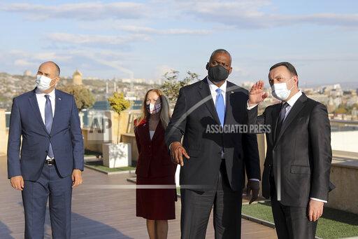In this handout photo provided by the Georgian Prime Minister Press Office, Georgian Prime Minister Irakli Garibashvili, right, gestures while talking with U.S. Defense Secretary Lloyd Austin, second right, as Minister of Georgian Defense Juansher Burchuladze stands near them during their meeting in Tbilisi, Georgia, Monday, Oct. 18, 2021. U.S. Defense Secretary Lloyd Austin headed to the Black Sea region aiming to shore up alliances with countries pressured by Russia and show gratitude for their contributions to the two-decade war in Afghanistan. (Georgian Prime Minister Press Office via AP)