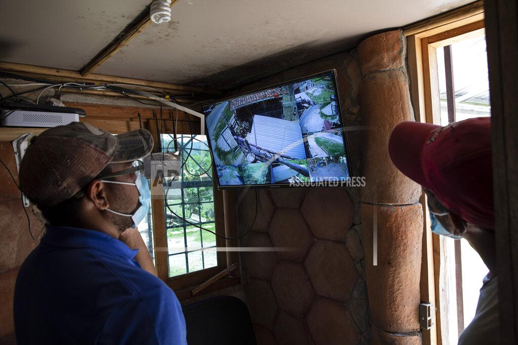 Rodrigo Abd Seminarians monitor security cameras at the mission and drug rehab center run by Friar Leopoldo Serrano, located in a valley marked by poverty and drug violence, in Mission San Francisco de Asis, Honduras, Thursday, June 24, 2021. Serrano who is routinely observed by men passing by in oversized SUVs with tinted windows, complained to the prosecutor’s office which led to the installation of surveillance systems. (AP Photo/Rodrigo Abd)