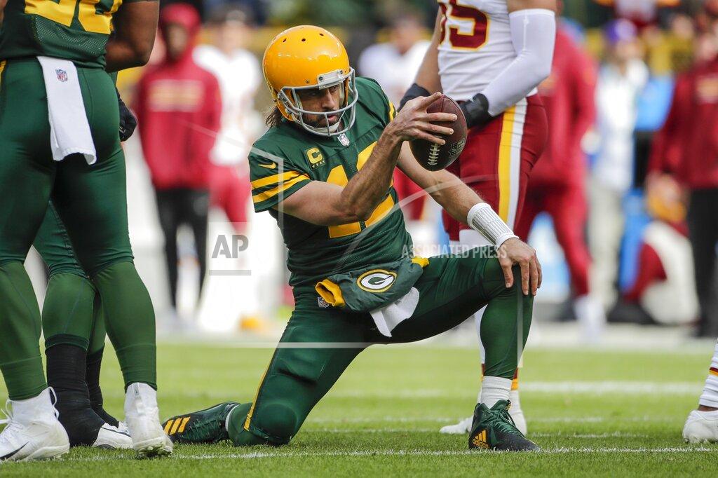 Aaron Gash Green Bay Packers' Aaron Rodgers celebrates his first down run during the first half of an NFL football game against the Washington Football Team Sunday, Oct. 24, 2021, in Green Bay, Wis. (AP Photo/Aaron Gash)