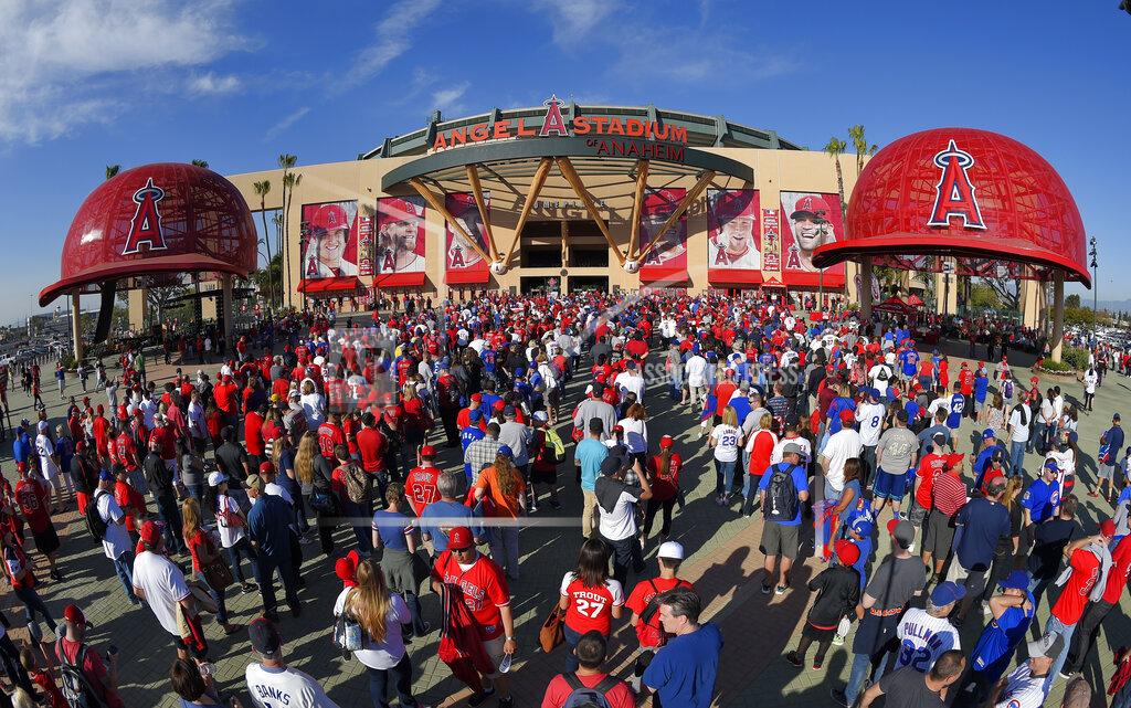 Mark J. Terrill FILE - In this April 4, 2016, file photo, fans line up outside Angel Stadium of Anaheim for an opening day baseball game between the Los Angeles Angels and the Chicago Cubs, in Los Angeles. It used to be that empty seats caused palpitations in team owners and college administrators relying on ticket sales and concessions to beef up the profit margins. Now, those empty seats – and short lines and clear concourses – will be the norm for a while as sports grapples with social distancing requirements. (AP Photo/Mark J. Terrill)