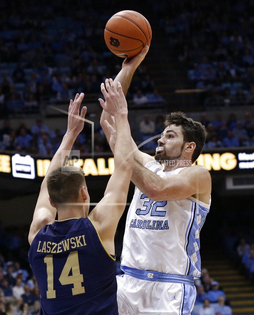 Gerry Broome North Carolina's Luke Maye (32) shoots while Notre Dame's Nate Laszewski (14) defends during the first half of an NCAA college basketball game in Chapel Hill, N.C., Tuesday, Jan. 15, 2019. (AP Photo/Gerry Broome)