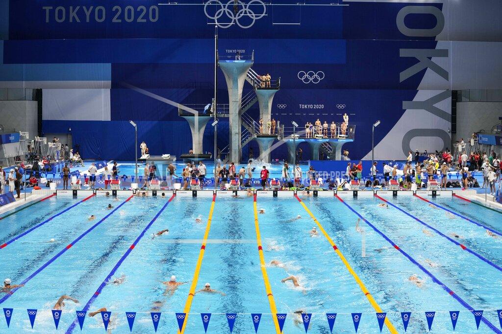 Martin Meissner FILE - In this July 23, 201 file photo, Athletes exercise during a swimming training session at the Tokyo Aquatics Centre at the 2020 Summer Olympics, in Tokyo, Japan. The Tokyo Aquatics Centre is a site to behold -- a towering, 15,000-seat venue that will host swimming and diving at the pandemic-delayed Summer Games.(AP Photo/Martin Meissner,File)