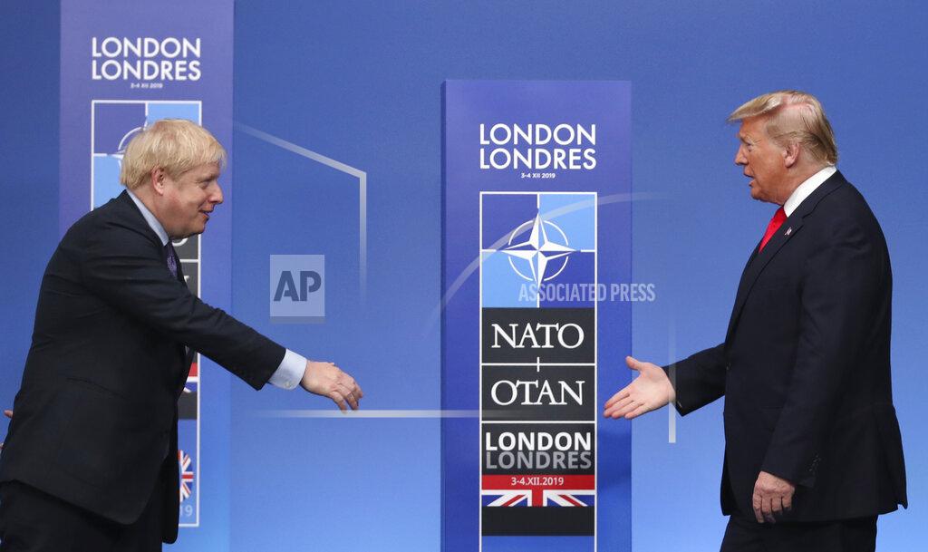 Francisco Seco FILE - In this Dec. 4, 2019 file photo British Prime Minister Boris Johnson, left, reaches out to shake hands with U.S. President Donald Trump at the official arrivals for a NATO leaders meeting at The Grove hotel and resort in Watford, Hertfordshire, England. If you're the leader of an increasingly isolated country, what's better — to keep an unreliable friend or gain a dependable critic? That's the dilemma facing British Prime Minister Boris Johnson over a U.S. election taking place weeks before the U.K. makes an economic split from the European Union at year's end and seeks new trade and diplomatic partners.(AP Photo/Francisco Seco, File)