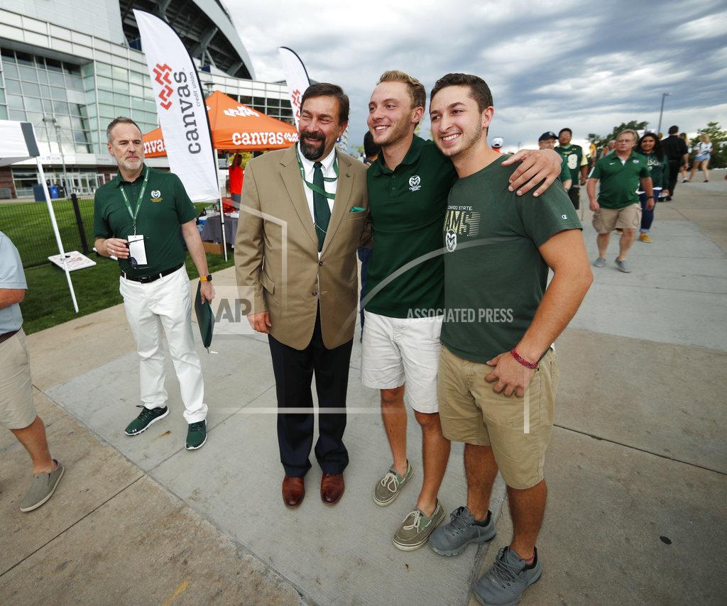 David Zalubowski Tony Frank, third from right, president of Colorado State University, greets students while headed in to watch Colorado State host Colorado in an NCAA college football game Friday, Aug. 31, 2018, in Denver. (AP Photo/David Zalubowski)