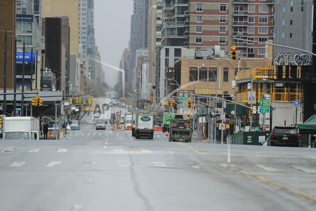 Frank Franklin Ii Cars navigate a mostly empty 11th avenue Friday, April 3, 2020, in New York. The new coronavirus causes mild or moderate symptoms for most people, but for some, especially older adults and people with existing health problems, it can cause more severe illness or death. (AP Photo/Frank Franklin II)
