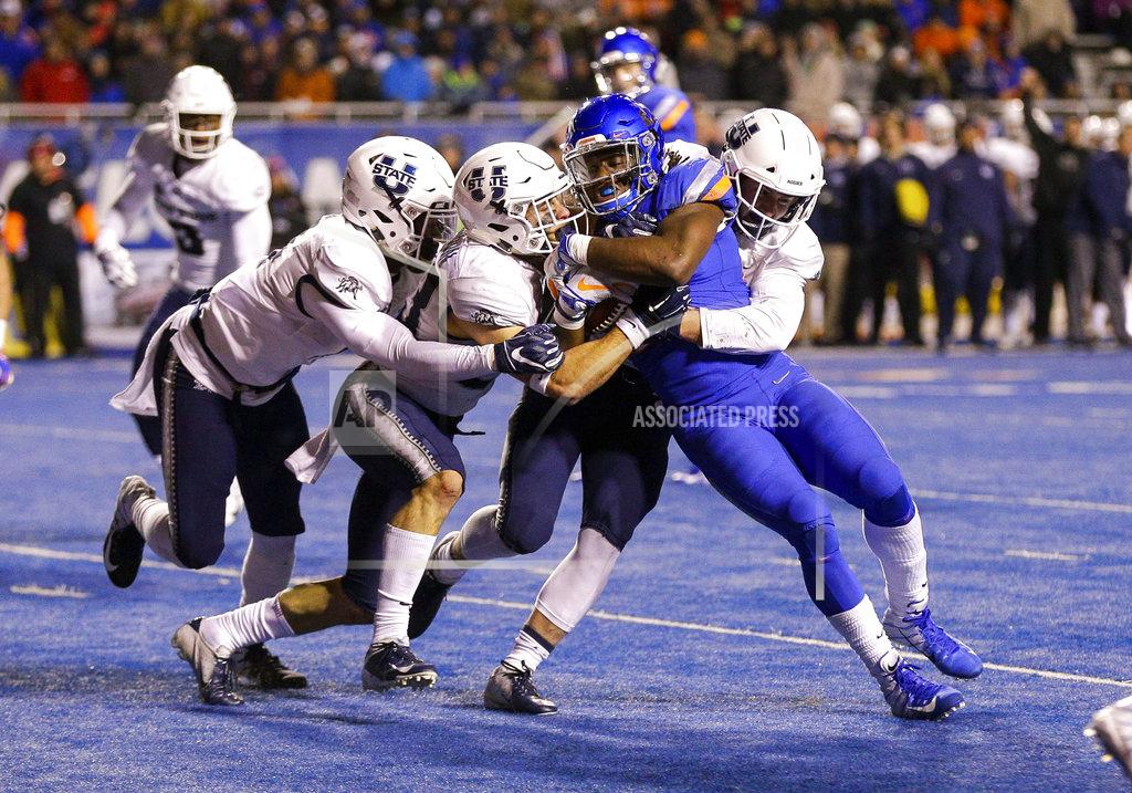 Steve Conner Boise State running back Alexander Mattison (22) is wrapped up by the Utah State defense in the second of an NCAA college football game, Saturday, Nov. 24, 2018, in Boise, Idaho. (AP Photo/Steve Conner)