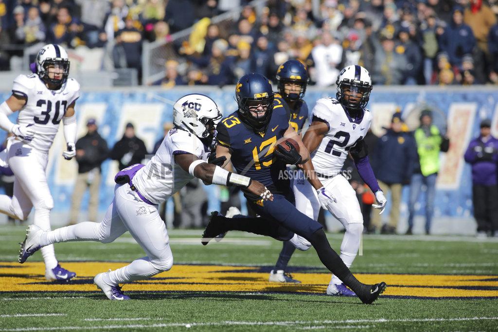 Ray Thompson West Virginia wide receiver David Sills V (13) is tackled by TCU linebacker Jawuan Johnson , left, during the first half of an NCAA college football game Saturday, Nov. 10, 2018, in Morgantown, W.Va. (AP Photo/Raymond Thompson)