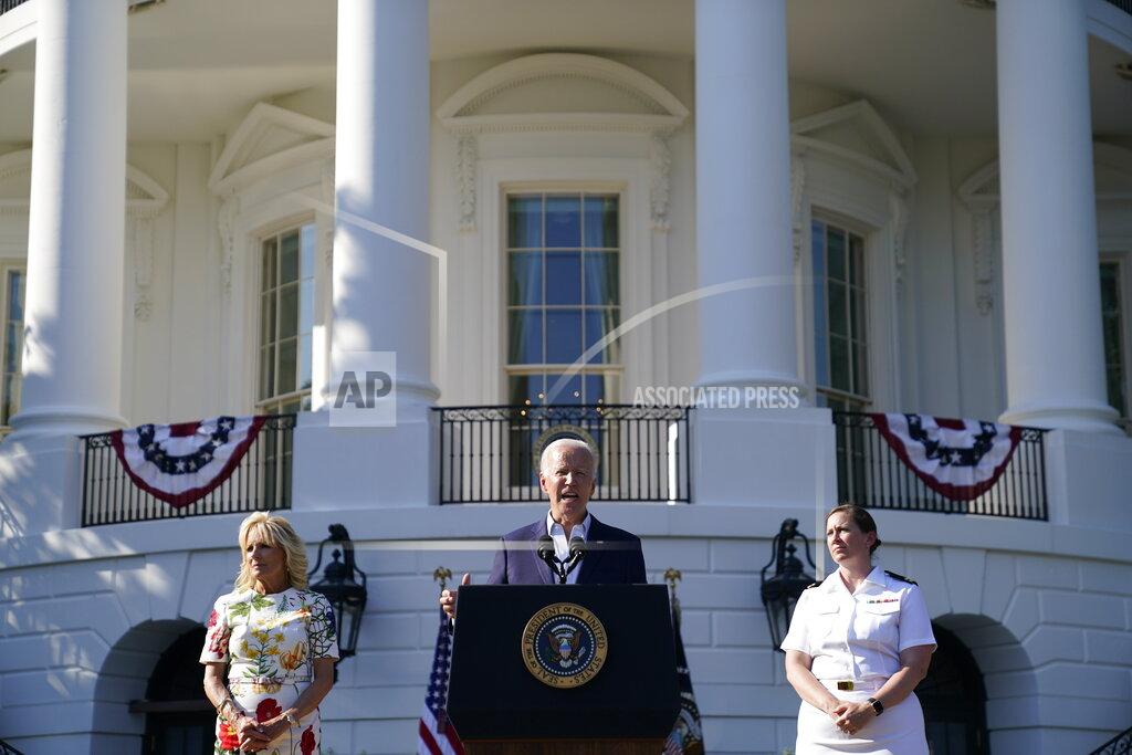 Evan Vucci President Joe Biden gesture after speaking at a Fourth of July celebration for military families on the South Lawn of the White House, Monday, July 4, 2022, in Washington. Listening are first lady Jill Biden, left, and Navy Chaplain Lt. Chandler Irwin. (AP Photo/Evan Vucci)