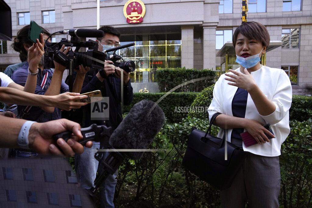 Ng Han Guan Teresa Xu speaks to journalists before a court session at the Chaoyang People's Court in Beijing, China, Friday, Sept. 17, 2021. After almost two years, the unmarried woman suing for the right to freeze her eggs in Beijing is getting her case heard in court Friday in a rare legal challenge against the country's restrictions on unmarried women in reproductive health. (AP Photo/Ng Han Guan)