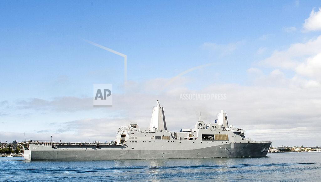 Mass Communication Specialist 2Nd Class Jonathan P. Idle In this Dec. 6, 2012, photo released by the U.S. Navy, the amphibious transport dock ship USS San Diego sails in San Diego Bay in San Diego, California. Two U.S. Navy warships operating in the Mideast have been affected by the coronavirus, authorities said Friday, Feb. 26, 2021, with the San Diego already at port in Bahrain and another heading to port elsewhere. (U.S. Navy/Mass Communication Specialist 2nd Class Jonathan P. Idle, via AP)