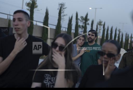 Mourners attend the funeral of the Israeli man Sagiv Ben Svi, killed by Hamas militants while attending a music festival, at a cemetery in Holon, central Israel, Thursday, Oct. 26, 2023. More than 1,400 people were killed and over 200 taken captive in an multi-front attack by the militant group that rules Gaza on Oct. 7.(AP Photo/Petros Giannakouris)