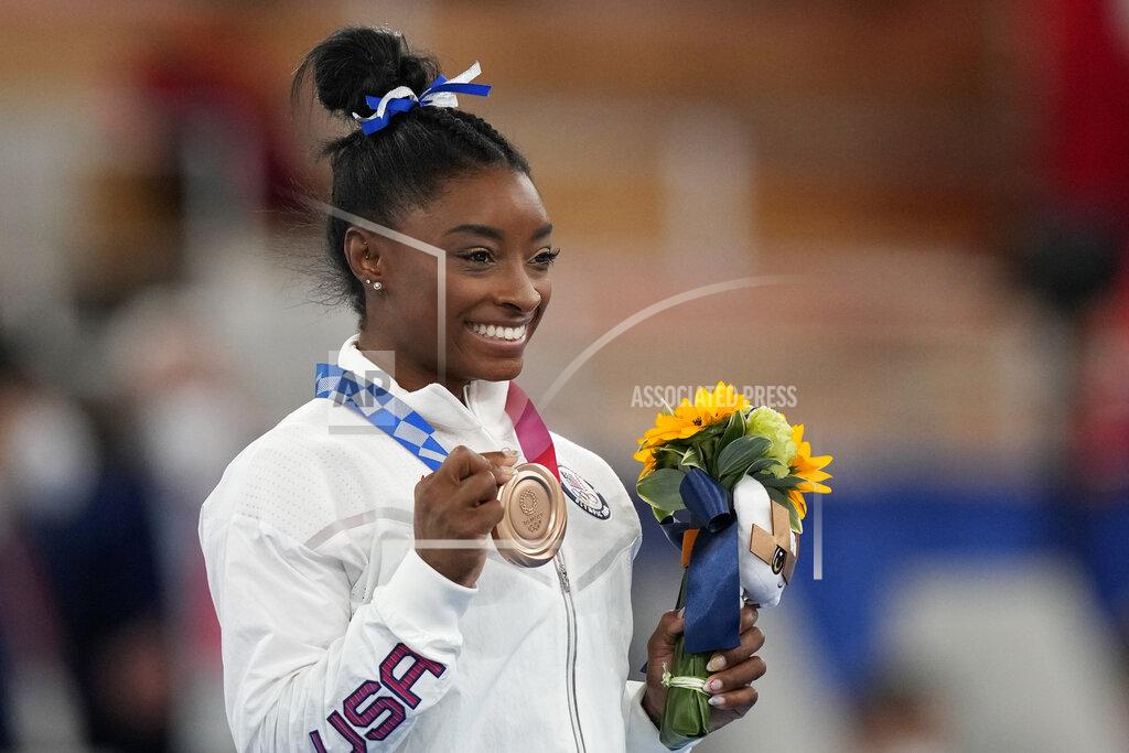 Natacha Pisarenko U.S. gymnast Simone Biles poses with her bronze medal for the artistic gymnastics women's balance beam apparatus at the 2020 Summer Olympics, Tuesday, Aug. 3, 2021, in Tokyo, Japan. (AP Photo/Natacha Pisarenko)