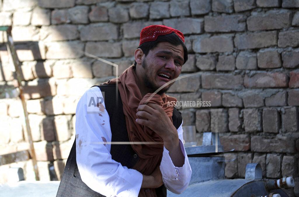 Rahmat Gul A Religious student cry inside a mosque after a bomb explosion in Shakar Dara district of Kabul, Afghanistan, Friday, May 14, 2021. A bomb ripped through a mosque in northern Kabul during Friday prayers killing 12 worshippers, Afghan police said. (AP Photo/Rahmat Gul)