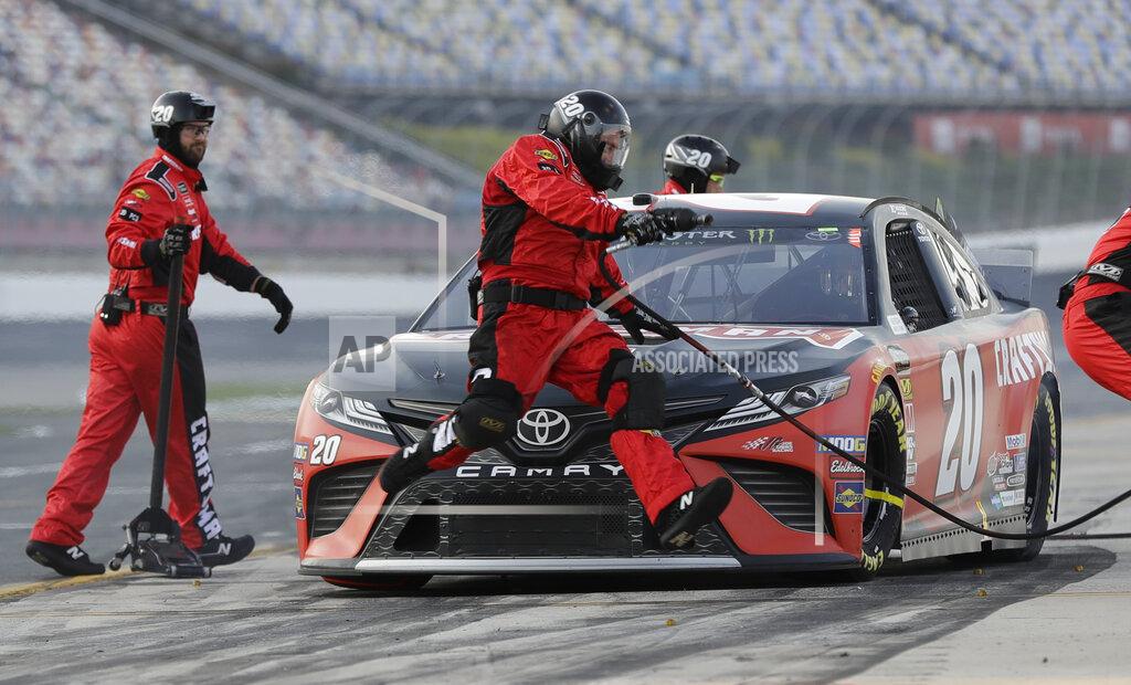 Chuck Burton A crew member jumps past the front of driver Erik Jones's car during qualifying for Saturday's NASCAR All-Star Cup series auto race at Charlotte Motor Speedway in Concord, N.C., Friday, May 17, 2019. (AP Photo/Chuck Burton)