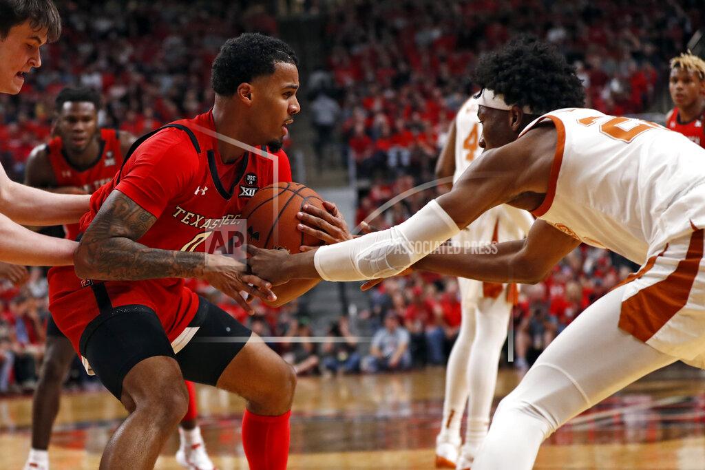 Brad Tollefson Texas' Kai Jones (22) tries to steal the ball from Texas Tech's Kyler Edwards (0) during the first half of an NCAA college basketball game Saturday, Feb. 29, 2020, in Lubbock, Texas. (AP Photo/Brad Tollefson)