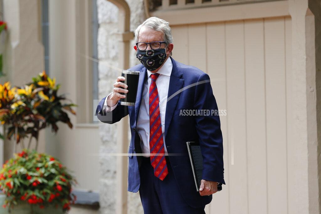 Jay Laprete Ohio Gov. Mike DeWine acknowledges members of the media while entering his residence after testing positive for COVID-19 earlier in the day Thursday, Aug. 6, 2020, in Bexley, Ohio. (AP Photo/Jay LaPrete)