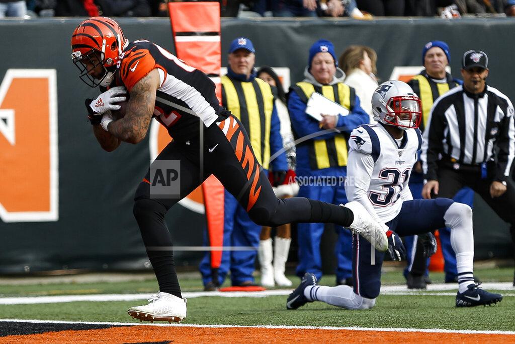 Frank Victores Cincinnati Bengals tight end Cethan Carter, left, runs in a touchdown after breaking a tackle from New England Patriots cornerback Jonathan Jones (31) in the first half of an NFL football game, Sunday, Dec. 15, 2019, in Cincinnati. (AP Photo/Frank Victores)