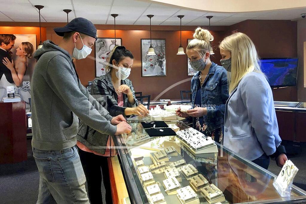 Sara Tewksbury This photo from KTVF-TV sows a couple picking out their wedding bands at Bishops Jewelry Gallery in Fairbanks, Alaska, on Friday, April 22, 2020. Alaska businesses slowly began reopening Friday in an effort to restart the state's economy. The state's largest city, Anchorage, will allow businesses to reopen beginning Monday. (Sara Tewksbury/KTVF-TV via AP)