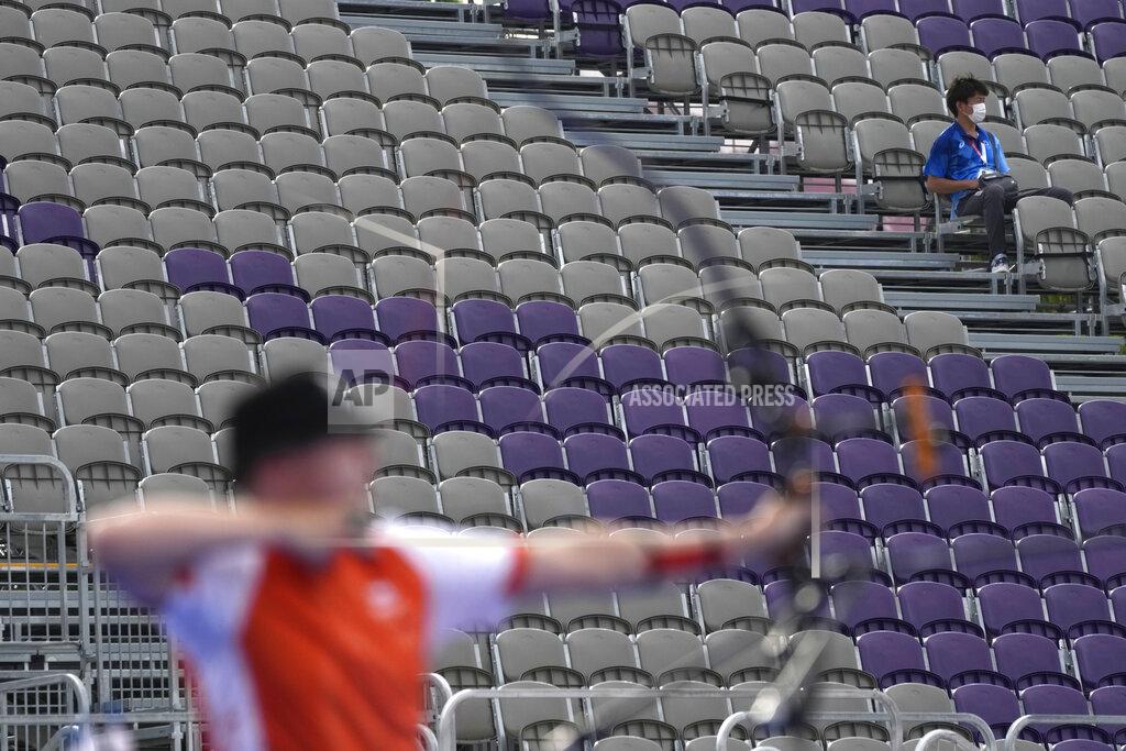 A man sits on the stands during the men's team competition at the 2020 Summer Olympics, Monday, July 26, 2021, in Tokyo, Japan. (AP Photo/Alessandra Tarantino)