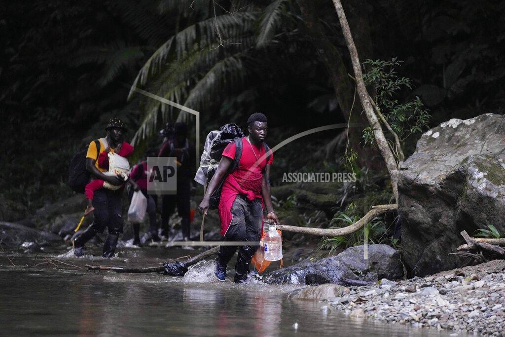 Fernando Vergara Migrants cross the Acandi River on their way north, in Acandi, Colombia, Wednesday, Sept. 15, 2021. The migrants, following a well-beaten, multi-nation journey towards the U.S., will continue their journey through the jungle known as the Darien Gap. (AP Photo/Fernando Vergara)