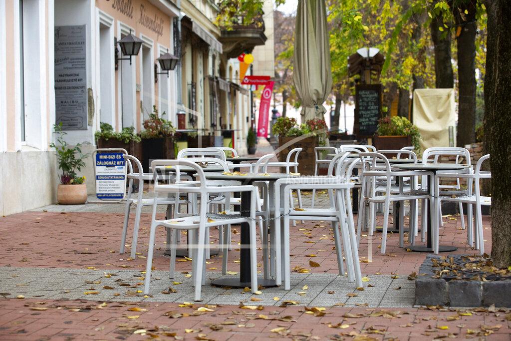 Gyorgy Varga Empty seats are seen at a restaurant's terrace in Nagykanizsa, Hungary, Wednesday, Nov. 11, 2020. The Hungarian government extended the curfew to be in force between 8pm and 5am, and restrict opening hours of shops and other businesses starting at midnight on Tuesday. The measures will be imposed for 30 days, and will be reassessed afterwards. (Gyorgy Varga/MTI via AP)