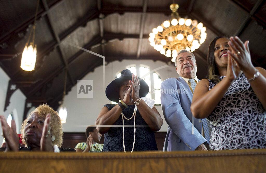 Branden Camp FILE - In this Sunday, July 10, 2016 file photo, parishioners clap during a worship service at the First Baptist Church, a predominantly African-American congregation, in Macon, Ga. There are two First Baptist Churches in Macon _ one black and one white. (AP Photo/Branden Camp)