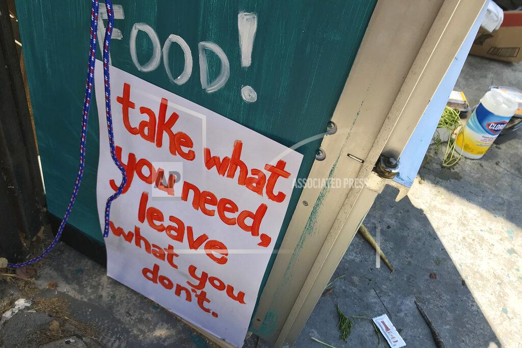 Aron Ranen A sign reads "take what you need, leave what you don't." on the side of a refrigerator filled with free food for people in need in Los Angeles on July 20, 2020. A network called, LA Community Fridge, has placed eight of across the Los Angeles area, from the Highland Park neighborhood north of downtown to Exposition Park near the University of Southern California to the seaside city of Long Beach, with plans to install more. (AP Photo/Aron Ranen)