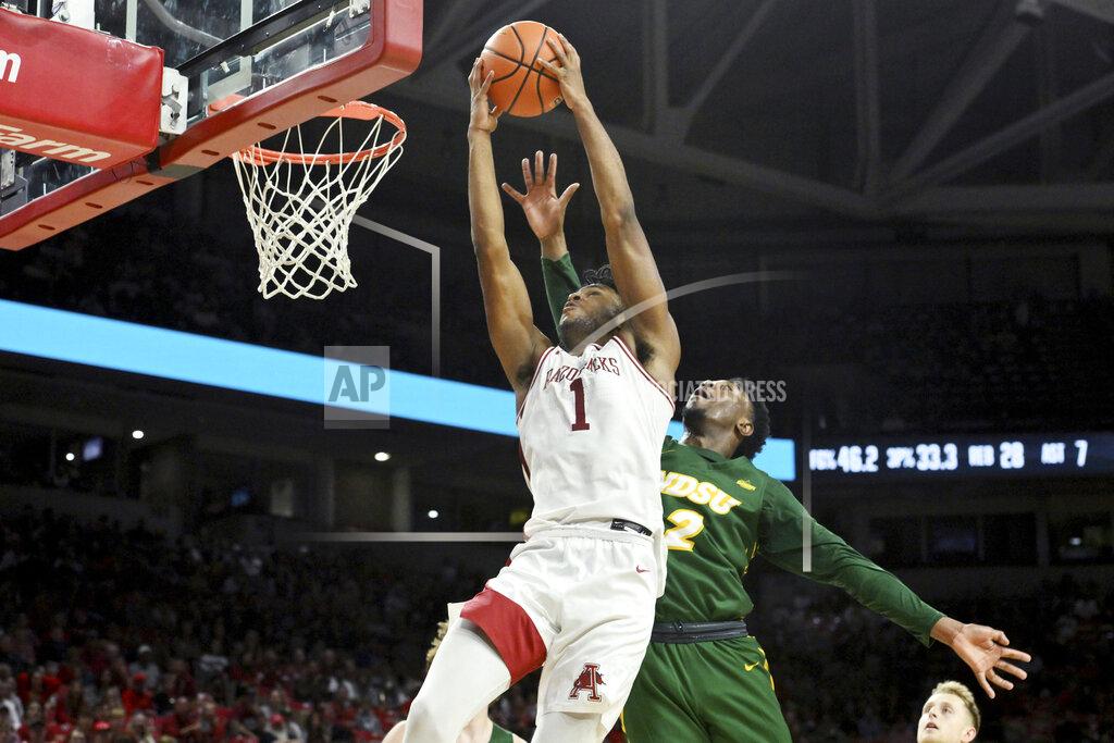 Michael Woods Arkansas guard Ricky Council IV (1) drives past North Dakota State guard Tajavis Miller (2) during the second half of an NCAA college basketball game Monday, Nov. 7, 2022, in Fayetteville, Ark. (AP Photo/Michael Woods)