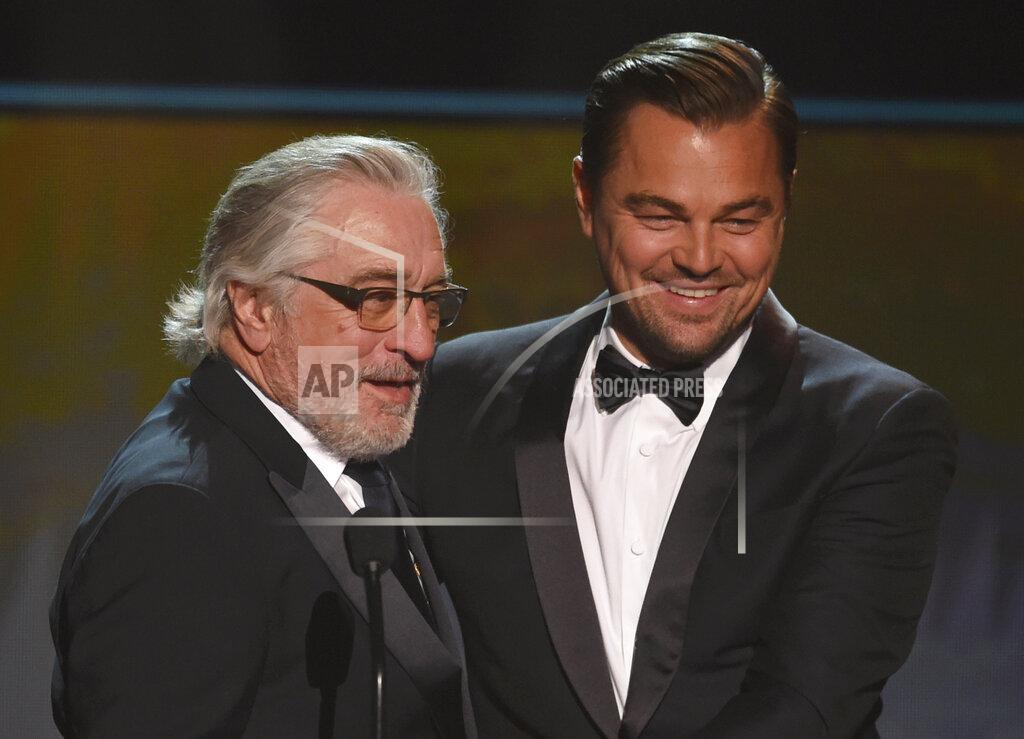 Chris Pizzello FILE - Leonardo DiCaprio, right, presents the lifetime achievement award to Robert De Niro at the 26th annual Screen Actors Guild Awards on Jan. 19, 2020, in Los Angeles. The actors are among the entertainers who took the initiative to make the best out of a challenging year. De Niro and DiCapio united to offer a fan the chance to win a walk-on part in Martin Scorsese's upcoming film, "Killers of the Flower Moon," starring both actors, as part of Michael Rubin's online charity auction, the All In Challenge. (Photo/Chris Pizzello, File)