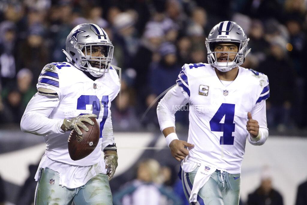 Matt Rourke FILE - In this Nov. 11, 2018, file photo, Dallas Cowboys running back Ezekiel Elliott, left, celebrates after catching a touchdown pass from quarterback Dak Prescott (4) during the second half of an NFL football game against the Philadelphia Eagles, in Philadelphia. Prescott has his backfield mate back now that Ezekiel Elliott's holdout is over. (AP Photo/Matt Rourke, File)