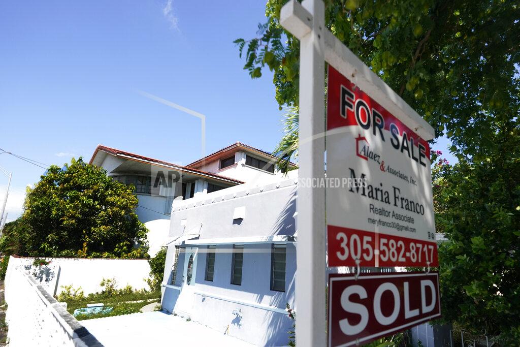 A home for sale with a "Sold" sign attached is viewed Monday, Oct. 12, 2020, in Miami Beach, Fla. U.S. long-term mortgage rates remained at record lows this week as the coronavirus pandemic continues to threaten the economy. (AP Photo/Wilfredo Lee)