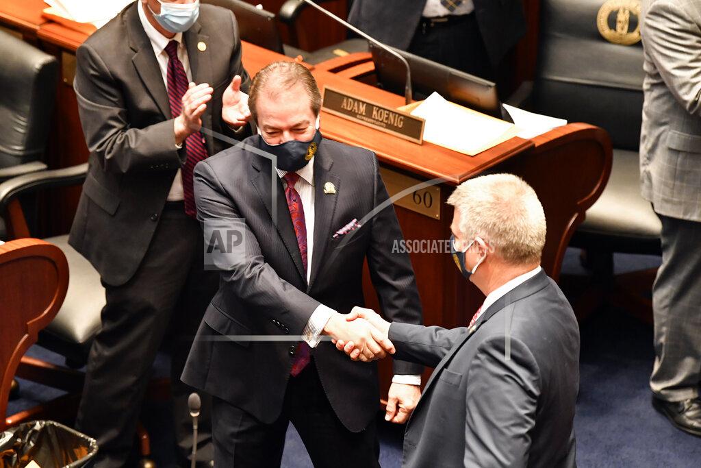 Timothy D. Easley Kentucky Speaker of The House David Osborne, left, is greeted by a house member as he walks into the house chamber in Frankfort, Ky., Tuesday, Jan. 5, 2021. (AP Photo/Timothy D. Easley)