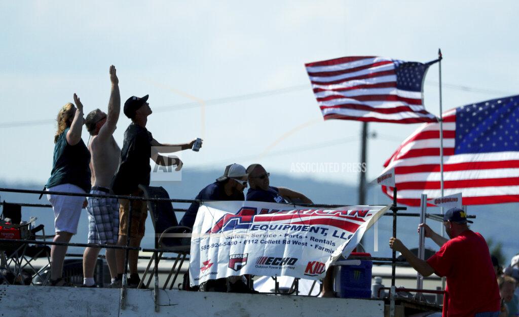 John Munson Race fans wave to a passing helicopter during a NASCAR Cup Series auto race at Watkins Glen International, Sunday, Aug. 4, 2019, in Watkins Glen, N.Y. (AP Photo/John Munson)