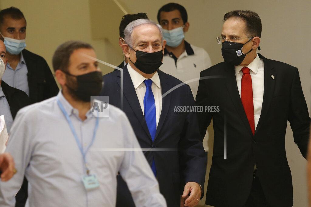 Israeli Prime Minister Benjamin Netanyahu, center, arrives at the Israeli Knesset, or Parliament in Jerusalem ahead of the discussion of the peace treaty with the United Arab Emirates, Thursday, Oct. 15, 2020. (Alex Kolomoisky/Pool Photo via AP)