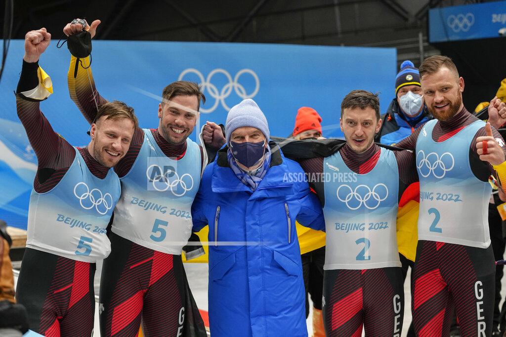 Mark Schiefelbein Tobias Wendl and Tobias Arlt, of Germany, left, and teammates Toni Eggert and Sascha Benecken celebrate with IOC president Thomas Bach after winning the gold and silver medals in the luge doubles at the 2022 Winter Olympics, Wednesday, Feb. 9, 2022, in the Yanqing district of Beijing. (AP Photo/Mark Schiefelbein)