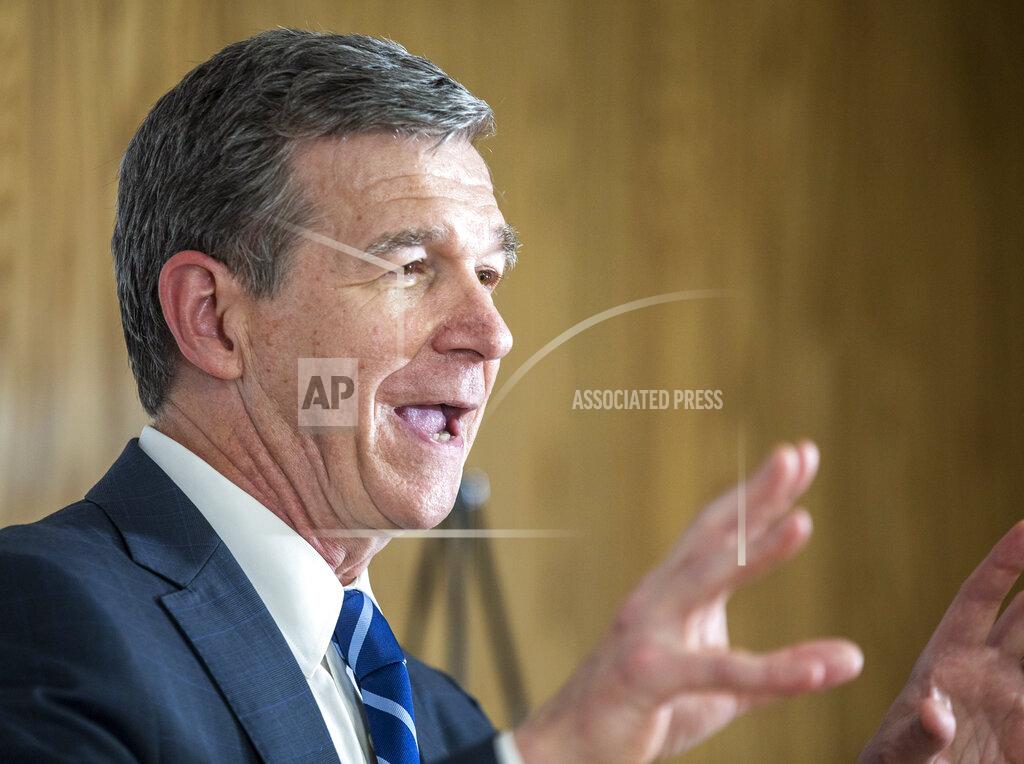 North Carolina Gov. Roy Cooper speaks to the gathered media after his tour of a COVID-19 vaccine clinic at the Pine Hall Brick plant in Madison, N.C., on Thursday, May 27, 2021. (Woody Marshall/News & Record via AP)
