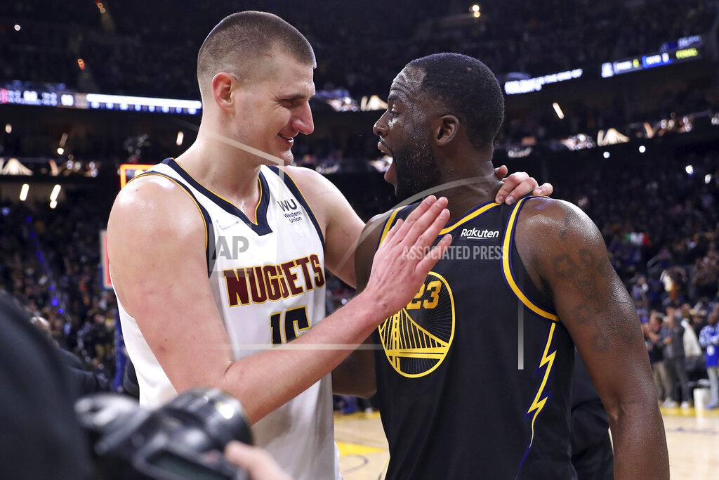 Scott Strazzante Golden State Warriors' Draymond Green, right, and Denver Nuggets' Nikola Jokic greet each other after the Warriors' 102-98 win in Game 5 of an NBA basketball first-round playoff series Wednesday, April 27, 2022, in San Francisco. (Scott Strazzante/San Francisco Chronicle via AP)