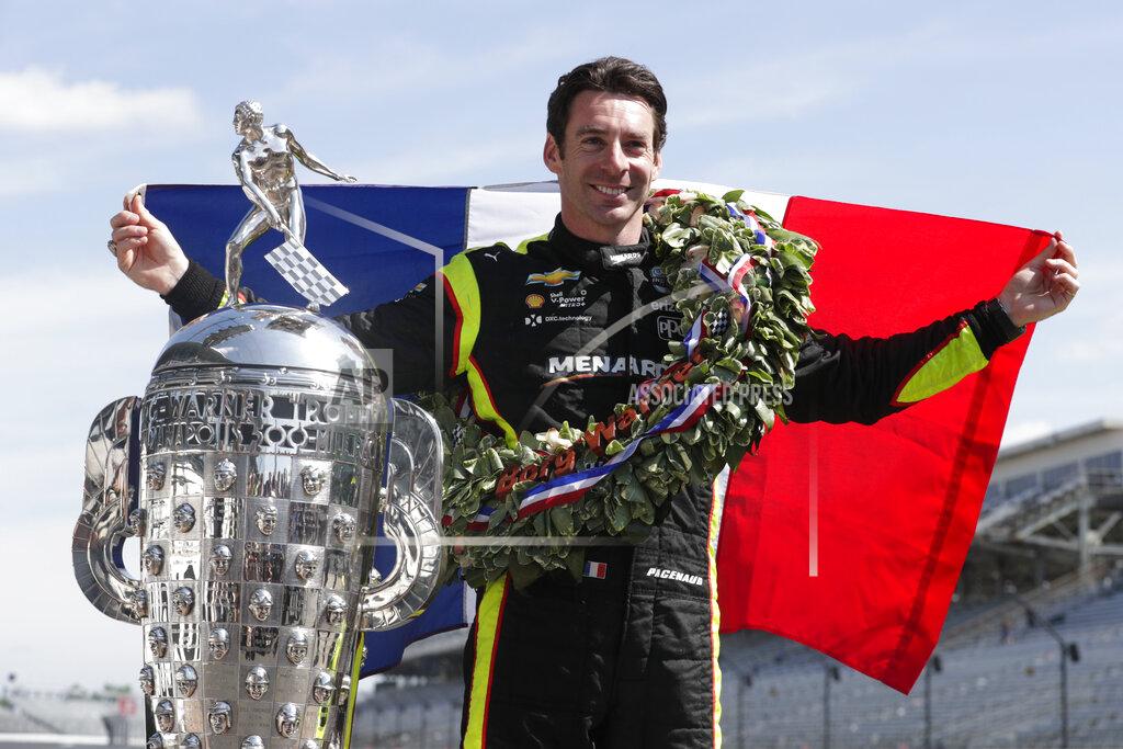 Simon Pagenaud, of France, winner of the 2019 Indianapolis 500 auto race, poses during the traditional winners photo session at the Indianapolis Motor Speedway in Indianapolis, Monday, May 27, 2019. (AP Photo/Michael Conroy)