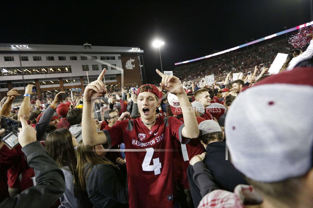 Young Kwak Washington State fans celebrate on the field after Washington State beat Oregon 34-20 in an NCAA college football game in Pullman, Wash., Saturday, Oct. 20, 2018. (AP Photo/Young Kwak)