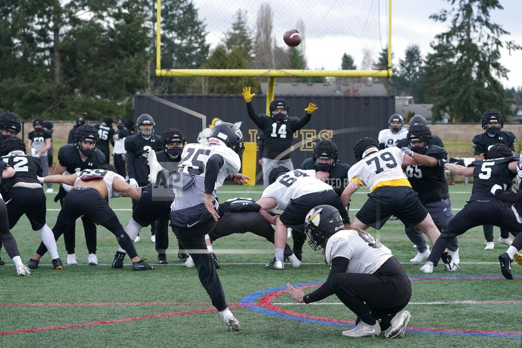 Ted S. Warren Pacific Lutheran college football players practice field goals Tuesday, Feb. 2, 2021, in Tacoma, Wash. For all the attention heaped on the FBS level of college football last fall as it tried to play, it will not be the only college football during the 2020-21 sports calendar as a handful of NCAA Division III and NAIA programs begin some form of a winter/spring season Saturday, Feb. 6. (AP Photo/Ted S. Warren)
